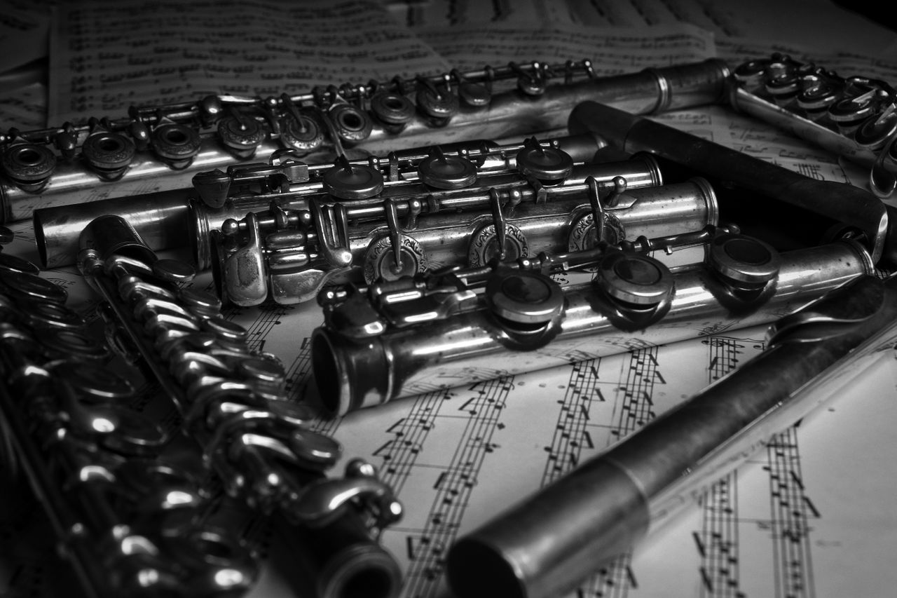 A collection of flutes arranged on sheet music, evoking the essence of classical music.